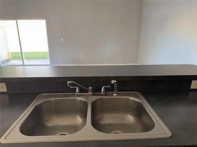a kitchen with a sink and cabinets