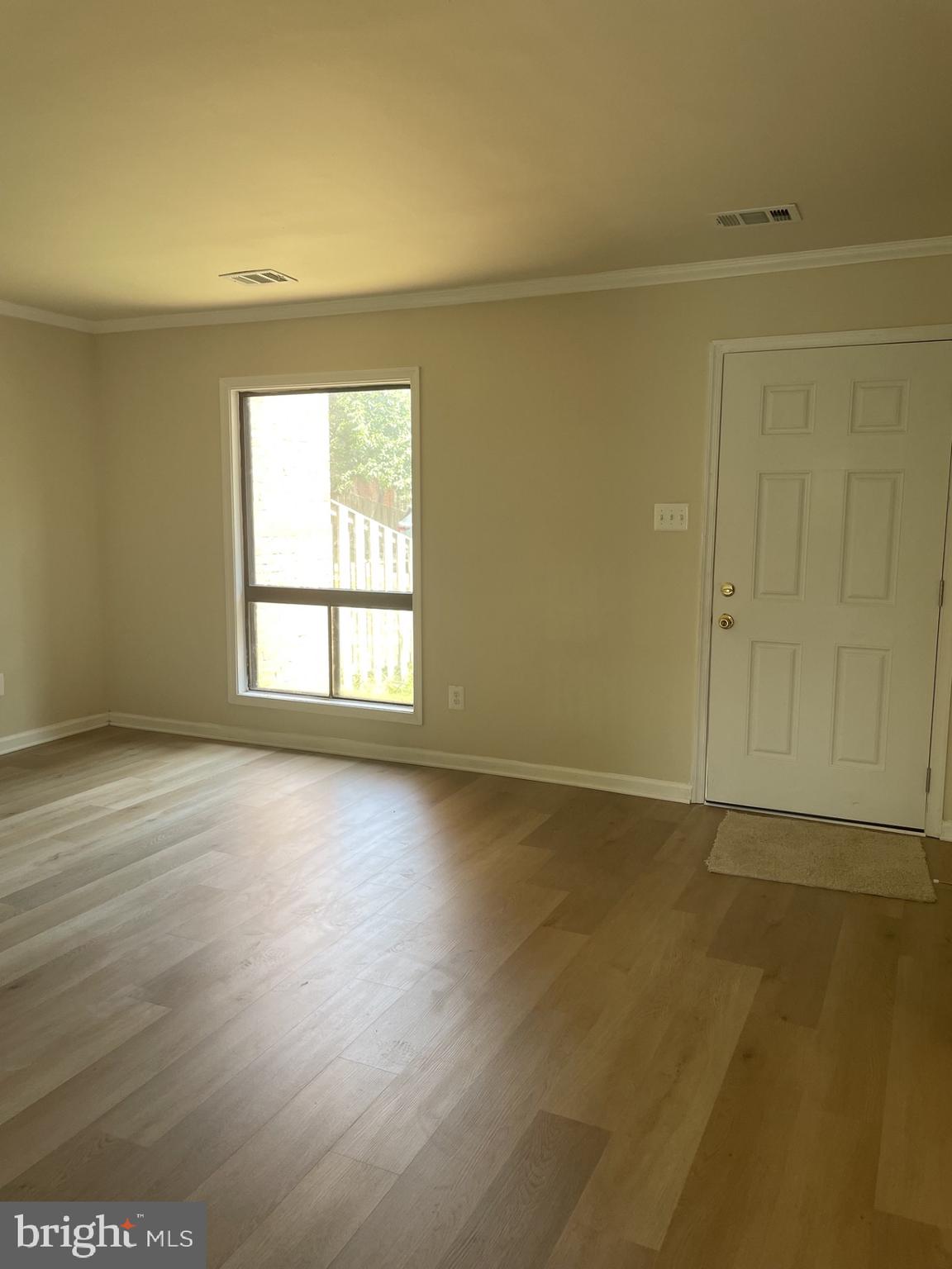 1287 Springtide Place Herndon, VA 20170 - Photo 5 of 23 an empty room with wooden floor and windows