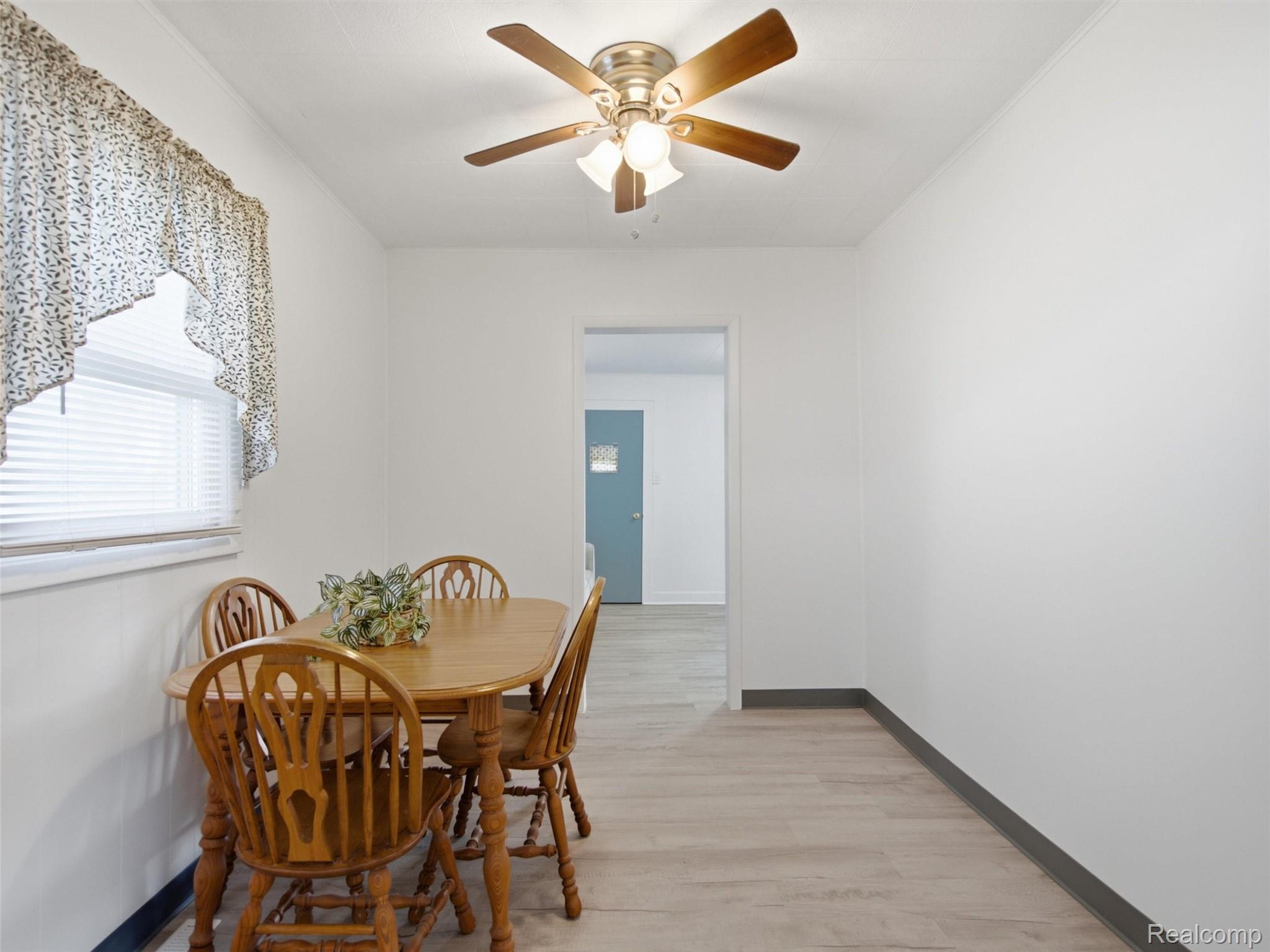808 Corwin Court Pontiac, MI 48340 - Photo 11 of 34 Dining area featuring new light wood-finish flooring, a ceiling fan with integrated lighting and a window with blinds