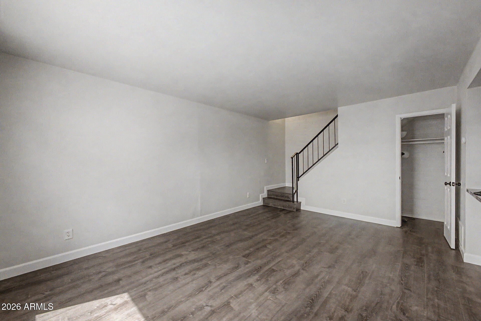600 South Dobson Road, Unit 177 Mesa, AZ 85202 - Photo 10 of 24 a view of an empty room with wooden floor and a window