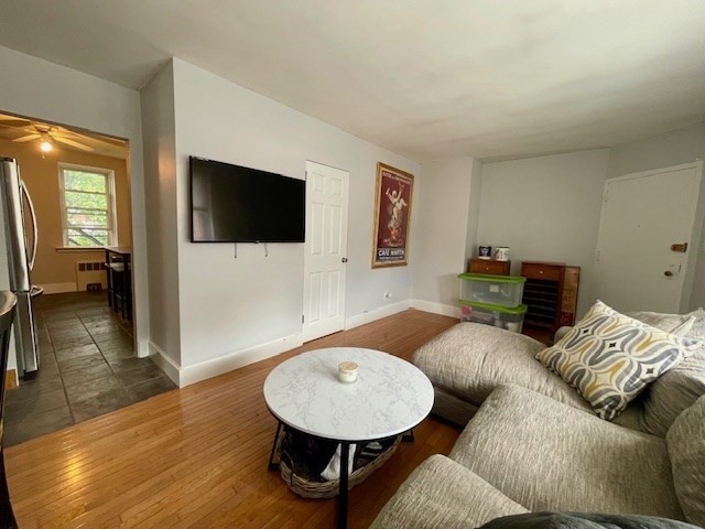 125 Farragut Road, Unit 46 Boston, MA 02127 - Photo 8 of 15 a living room with furniture and a flat screen tv