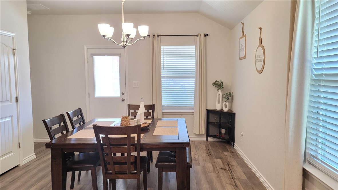 7633 Shadow Rider Lane Corpus Christi, TX 78414 - Photo 11 of 23 a view of a dining room with furniture and wooden floor