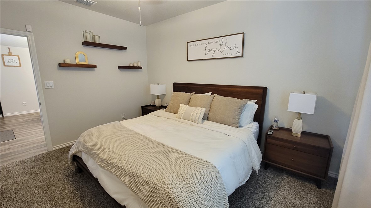 7633 Shadow Rider Lane Corpus Christi, TX 78414 - Photo 14 of 23 a bedroom with bed and wooden floor