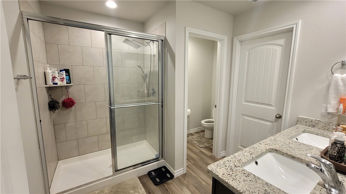 7633 Shadow Rider Lane Corpus Christi, TX 78414 - Photo 15 of 23 a bathroom with a granite countertop sink and a mirror