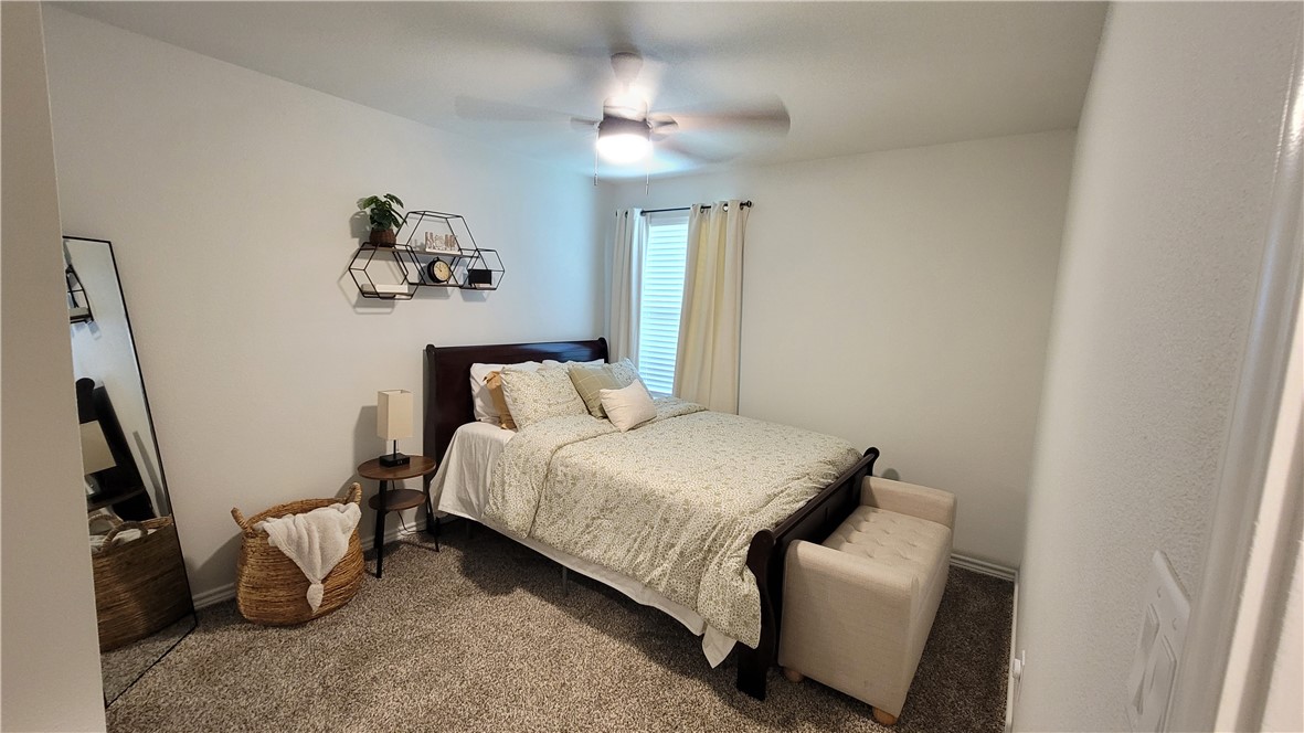 7633 Shadow Rider Lane Corpus Christi, TX 78414 - Photo 17 of 23 a bedroom with a bed and a chandelier