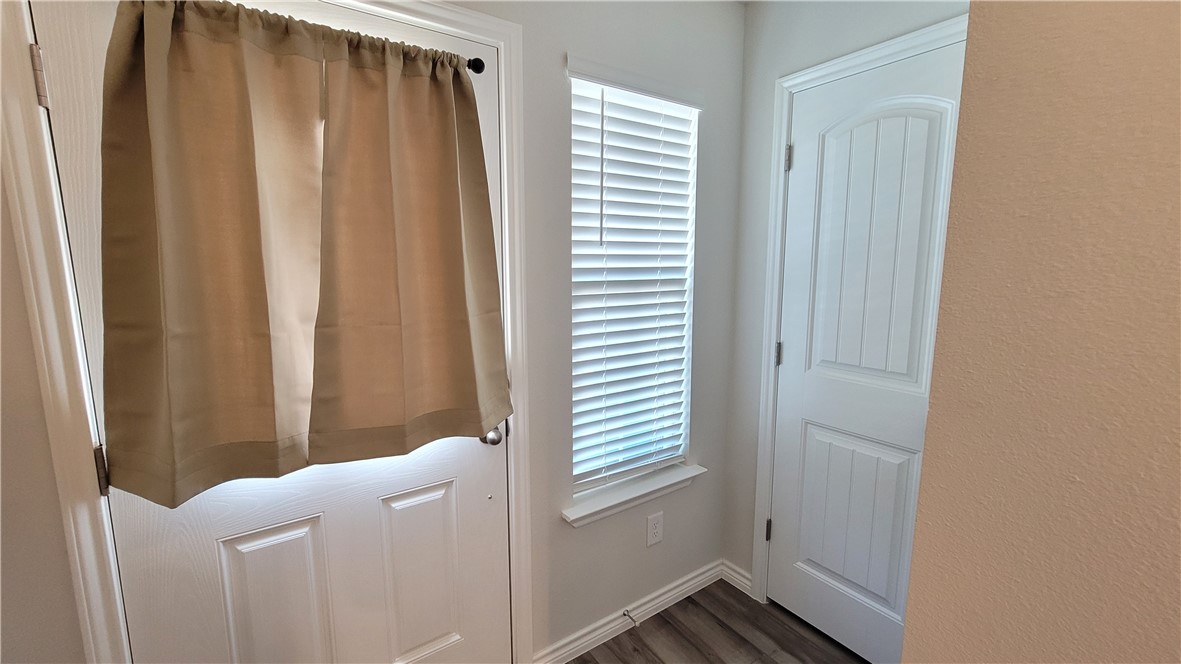 7633 Shadow Rider Lane Corpus Christi, TX 78414 - Photo 4 of 23 a bathroom with a shower curtain and a window