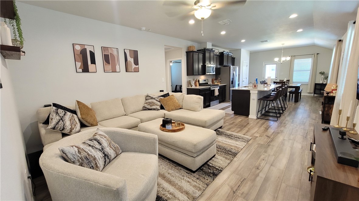 7633 Shadow Rider Lane Corpus Christi, TX 78414 - Photo 6 of 23 a living room with furniture kitchen view and a flat screen tv