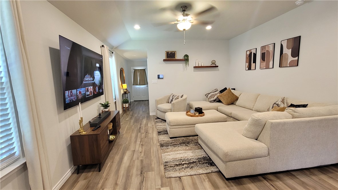 7633 Shadow Rider Lane Corpus Christi, TX 78414 - Photo 7 of 23 a living room with furniture and a flat screen tv