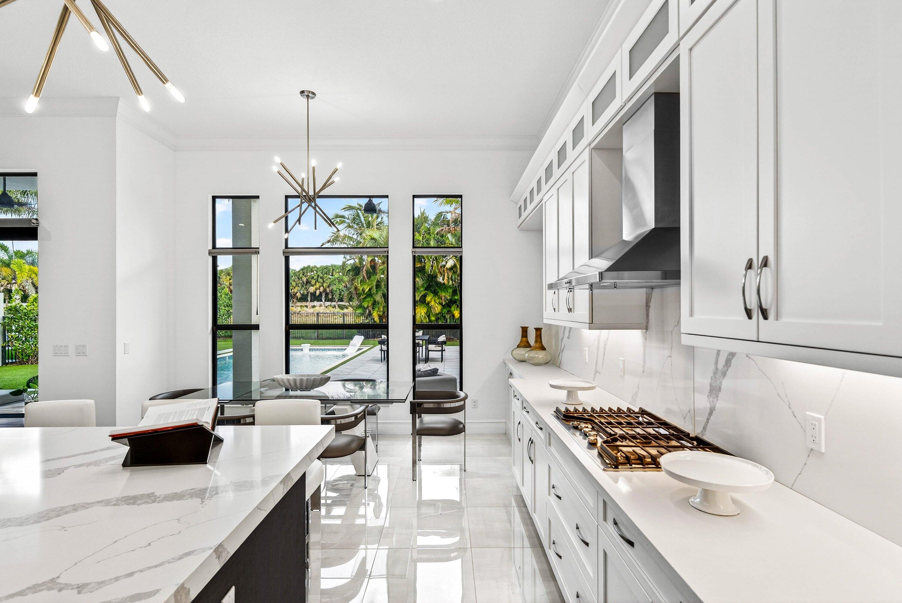 9065 Benedetta Place Boca Raton, FL 33496 - Photo 11 of 52 a kitchen with sink stove and cabinets