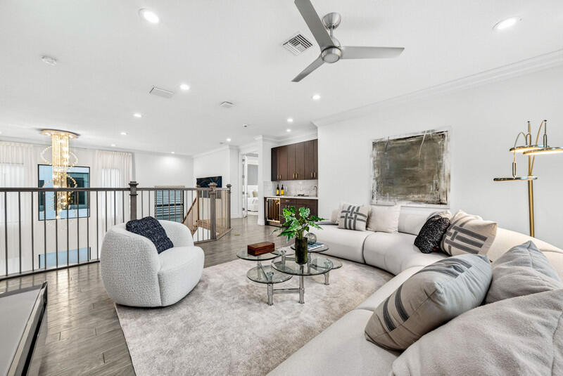 9065 Benedetta Place Boca Raton, FL 33496 - Photo 24 of 51 a living room with furniture a ceiling fan and a rug