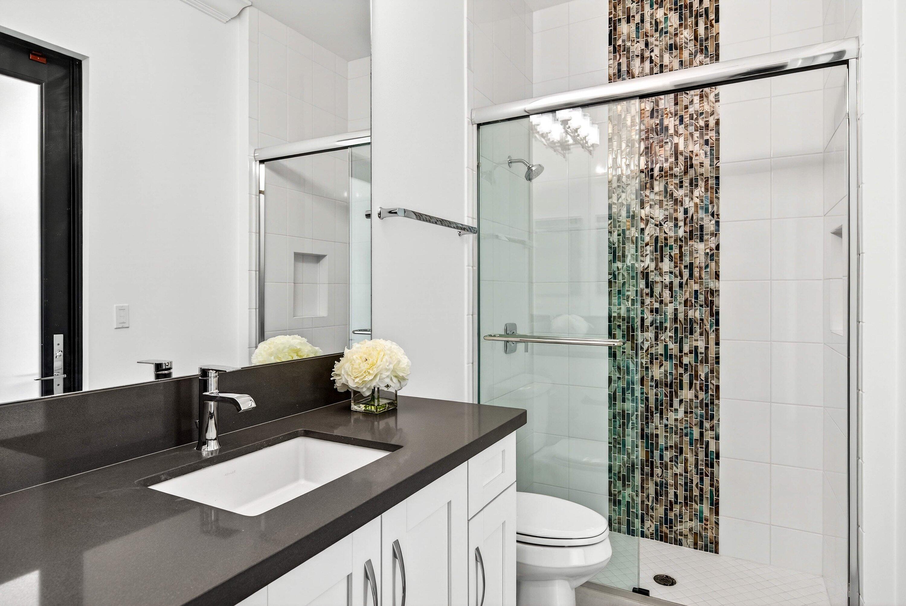 9065 Benedetta Place Boca Raton, FL 33496 - Photo 29 of 51 a bathroom with a granite countertop sink a toilet and shower