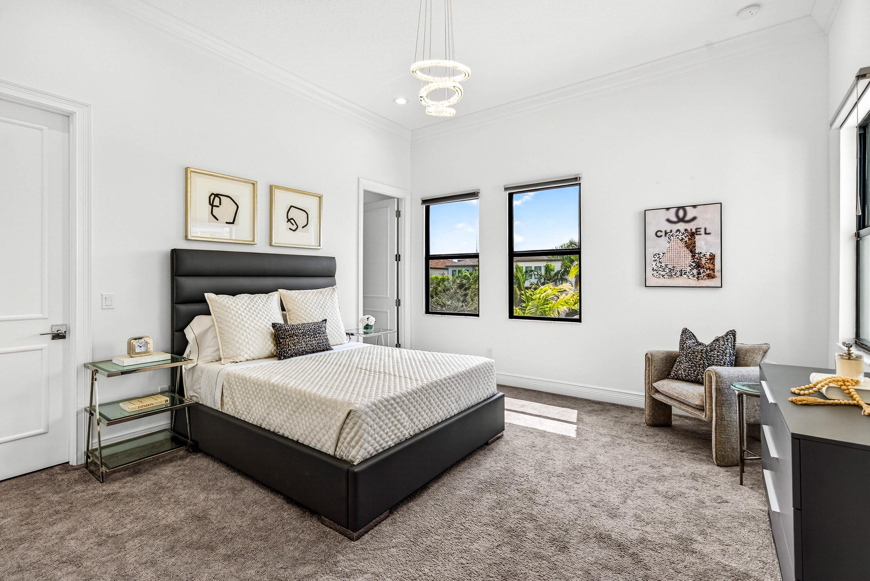 9065 Benedetta Place Boca Raton, FL 33496 - Photo 30 of 51 a bedroom with a bed table and window