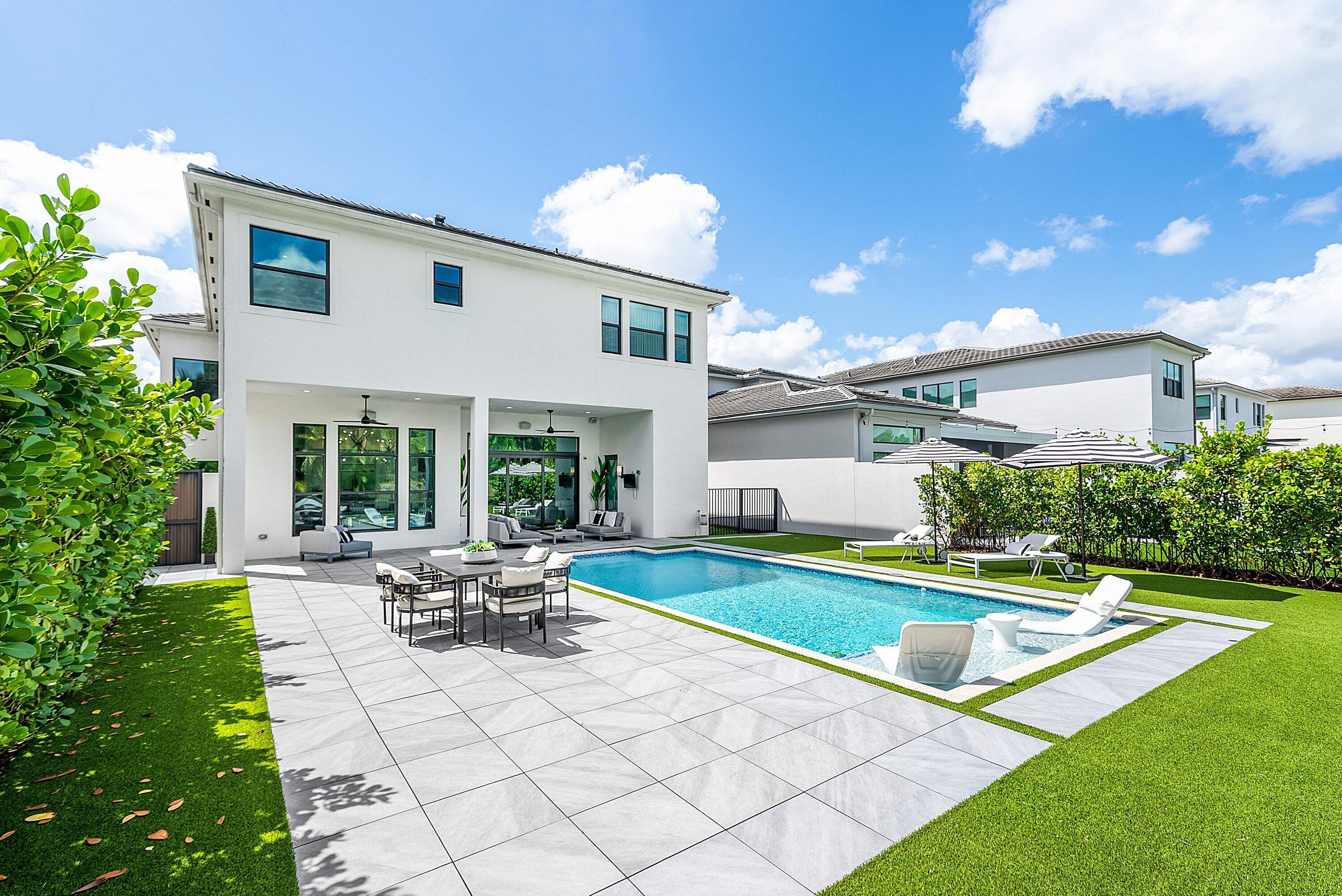 9065 Benedetta Place Boca Raton, FL 33496 - Photo 36 of 51 a view of house with swimming pool outdoor seating and yard