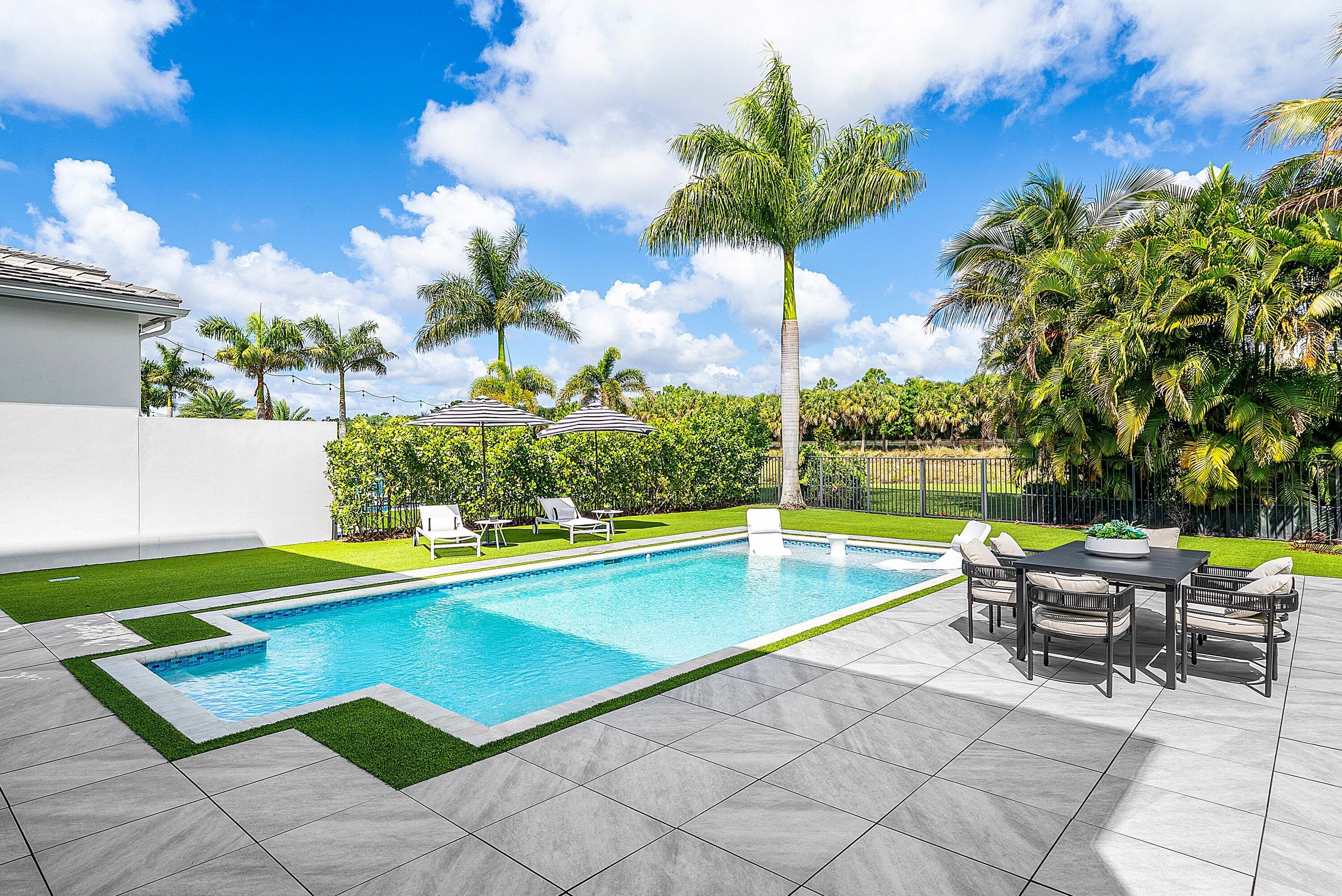 9065 Benedetta Place Boca Raton, FL 33496 - Photo 38 of 52 a view of a swimming pool with a lounge chairs