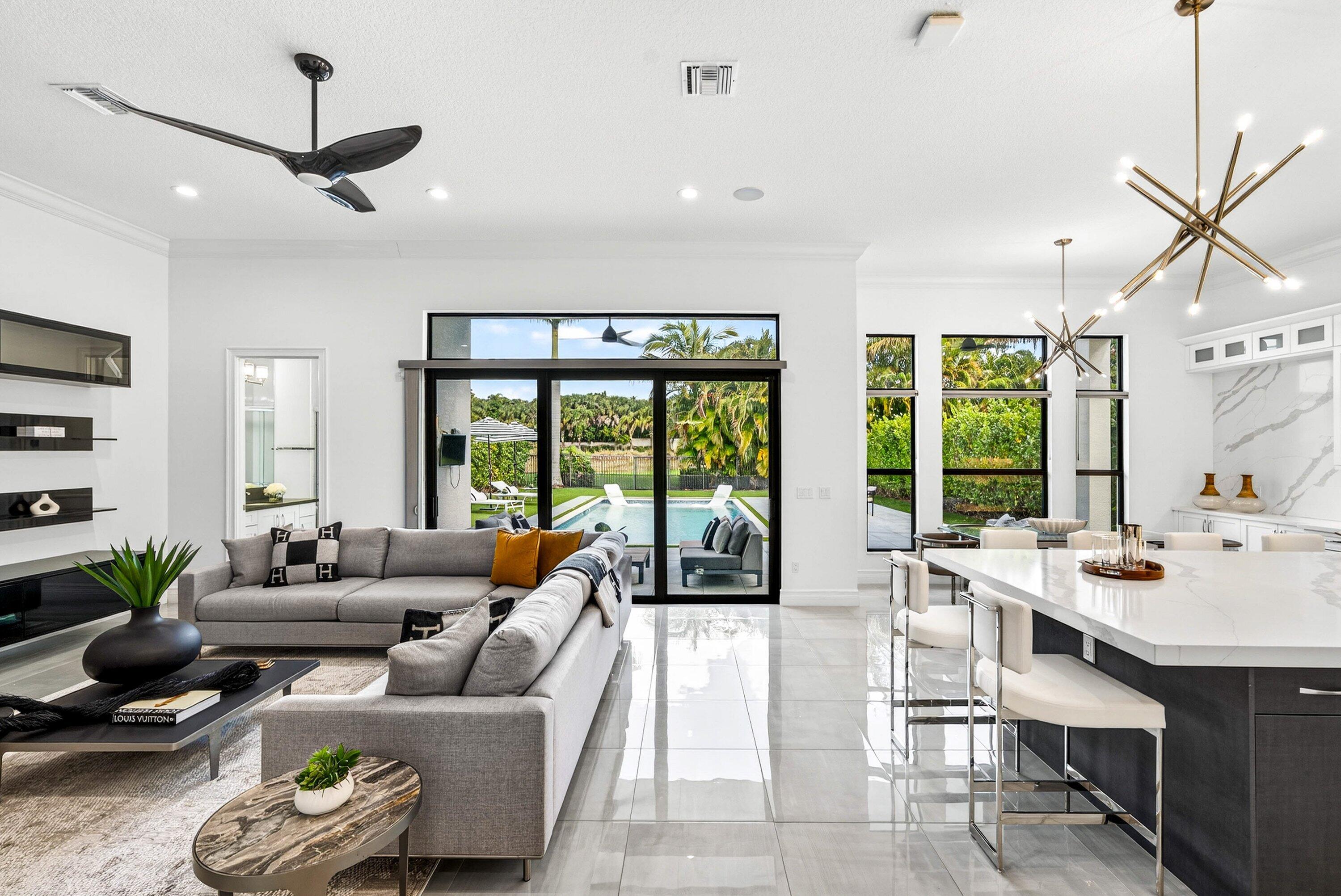 9065 Benedetta Place Boca Raton, FL 33496 - Photo 9 of 51 a living room with furniture and large windows