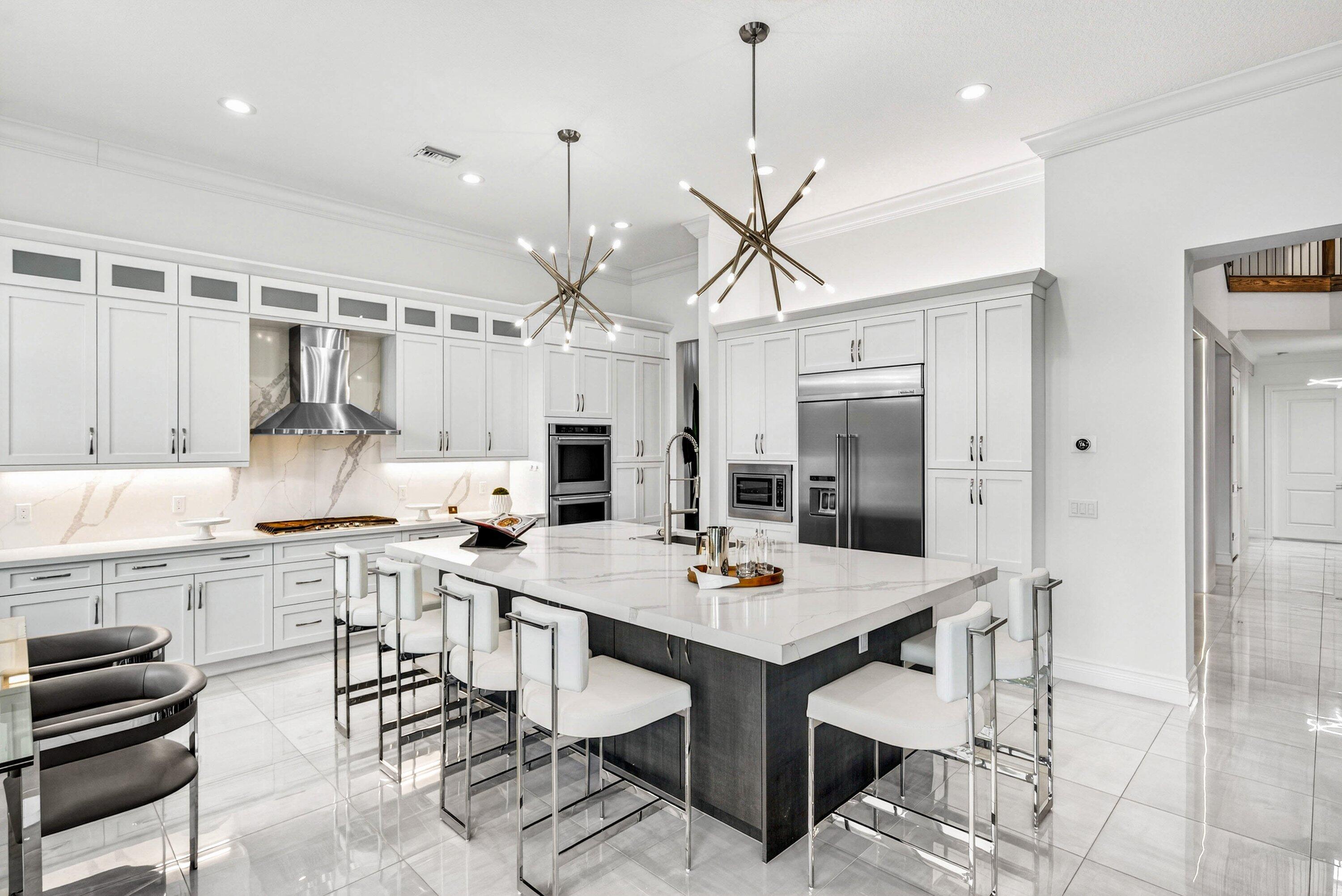 9065 Benedetta Place Boca Raton, FL 33496 - Photo 9 of 52 a kitchen with a table and chairs in it