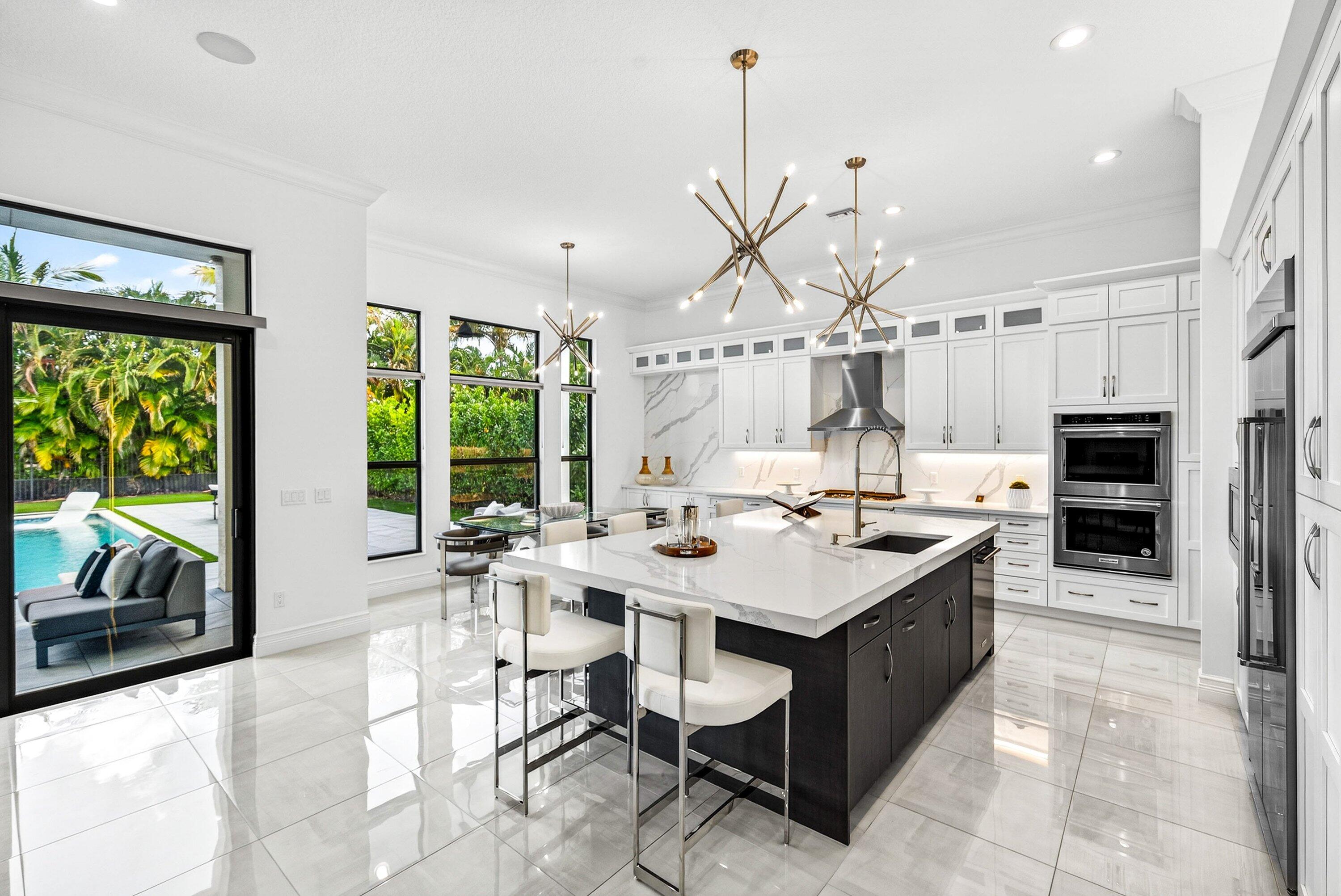 9065 Benedetta Place Boca Raton, FL 33496 - Photo 10 of 51 a room with stainless steel appliances kitchen island granite countertop a sink and a large window