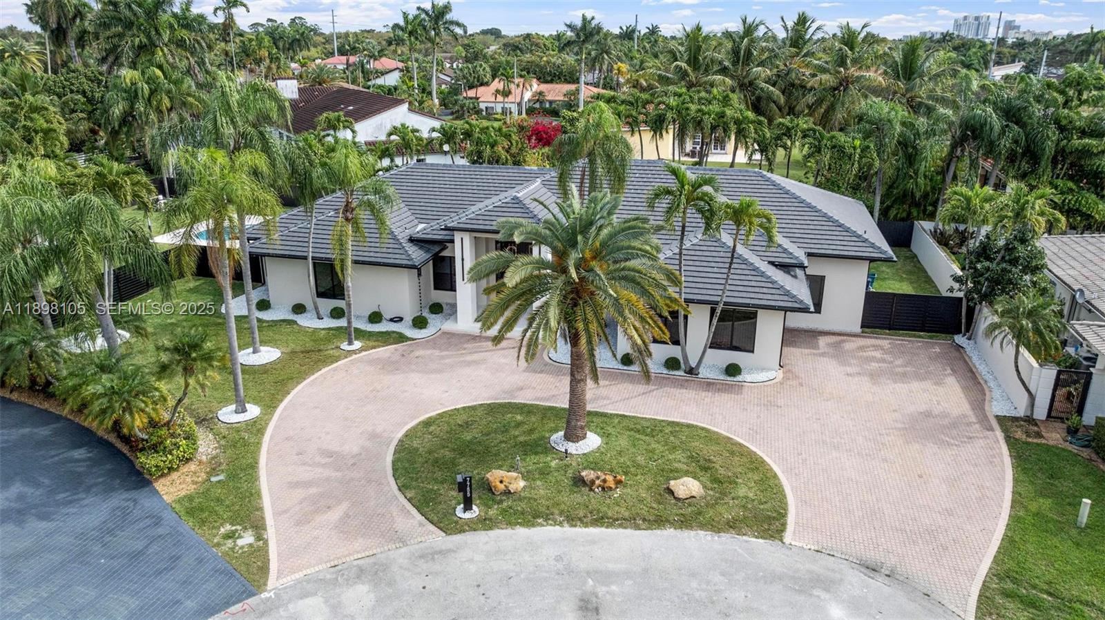 an aerial view of a house with garden space and trees