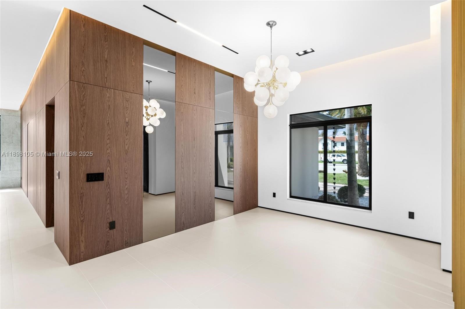 7755 Southwest 85th Court Miami, FL 33143 - Photo 11 of 70 a view of a hallway with a chandelier fan and windows