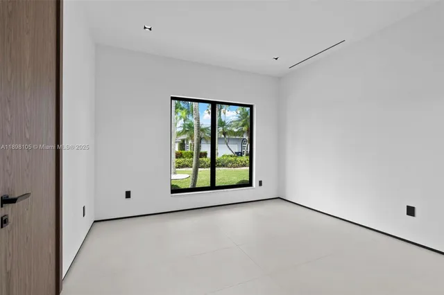 a view of an empty room with a fireplace and cabinets