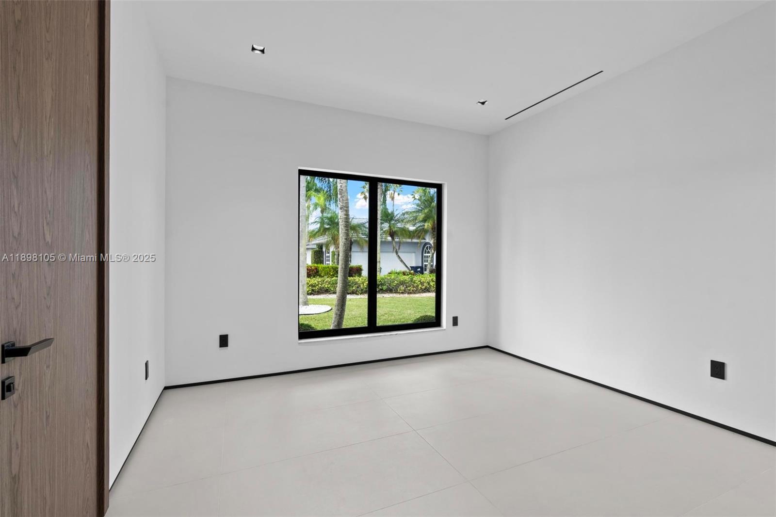 7755 Southwest 85th Court Miami, FL 33143 - Photo 34 of 70 an empty room with a window