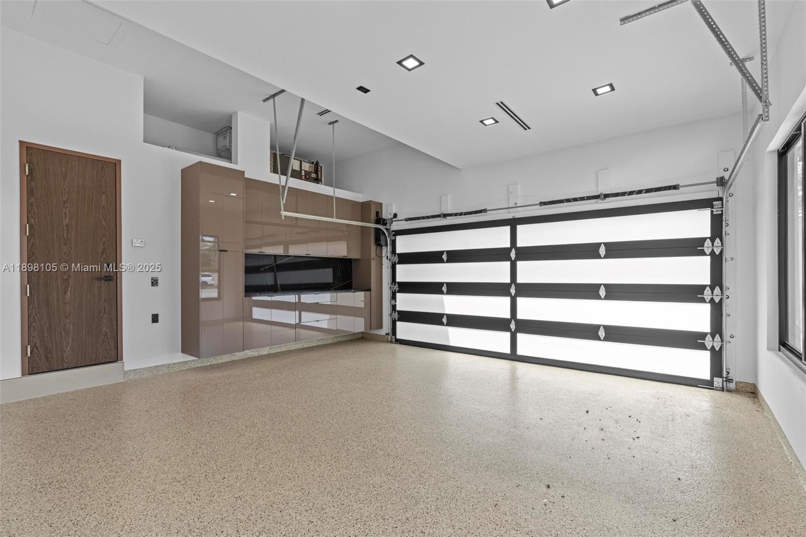 7755 Southwest 85th Court Miami, FL 33143 - Photo 46 of 70 a view of an empty room with a fireplace and cabinets