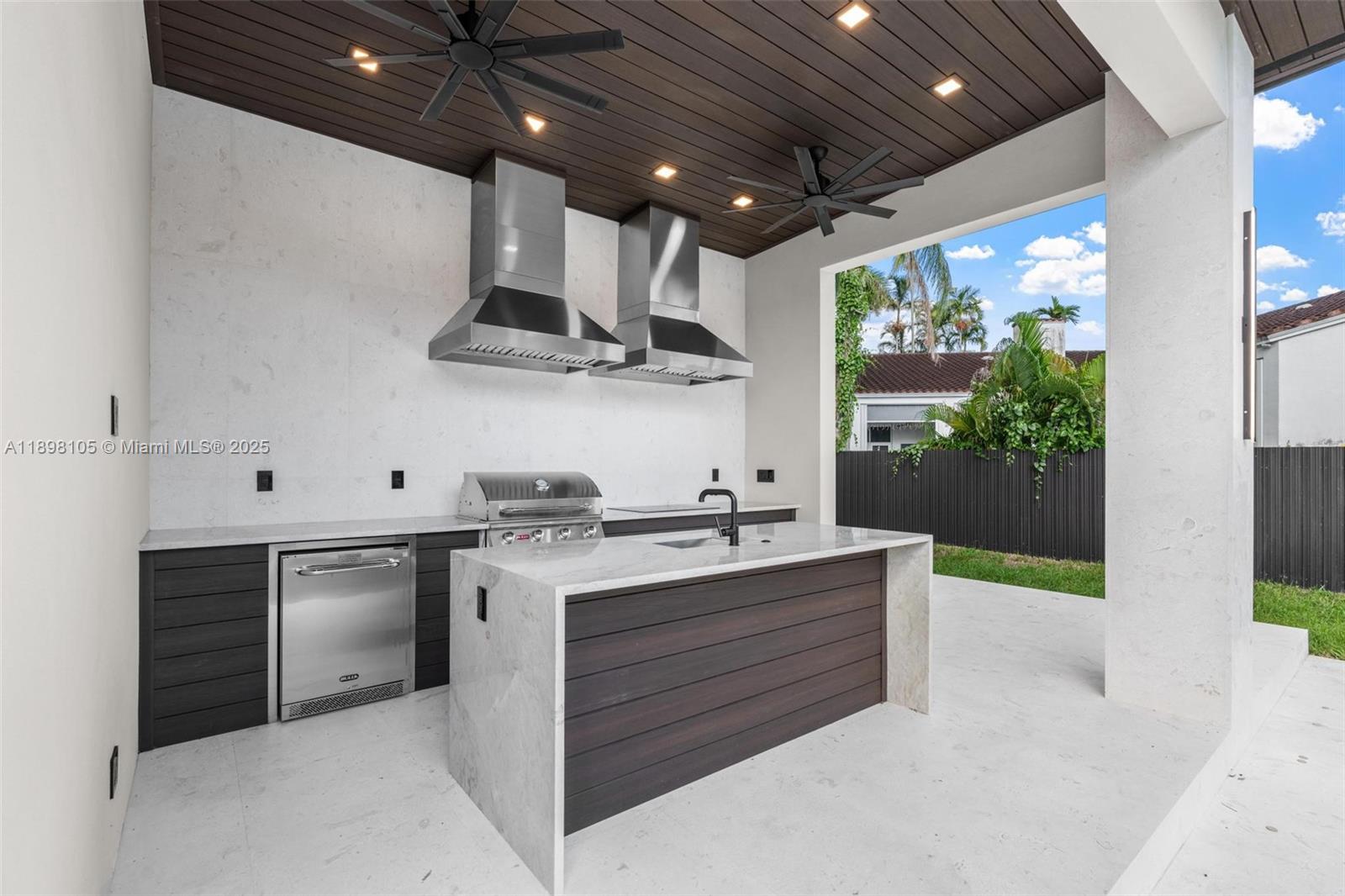 7755 Southwest 85th Court Miami, FL 33143 - Photo 58 of 70 a kitchen with a sink stainless steel appliances and cabinets