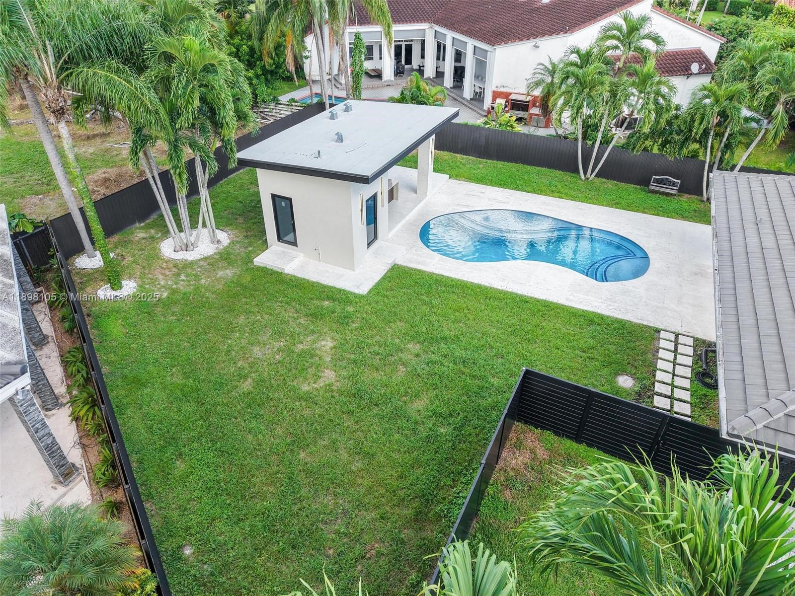 7755 Southwest 85th Court Miami, FL 33143 - Photo 66 of 70 a view of a house with a backyard and a patio