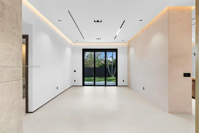a view of a hallway with a chandelier fan and windows