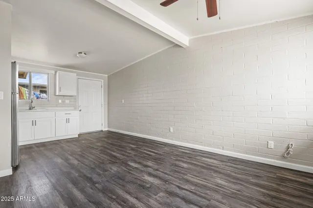 a view of a kitchen with wooden floor and a sink