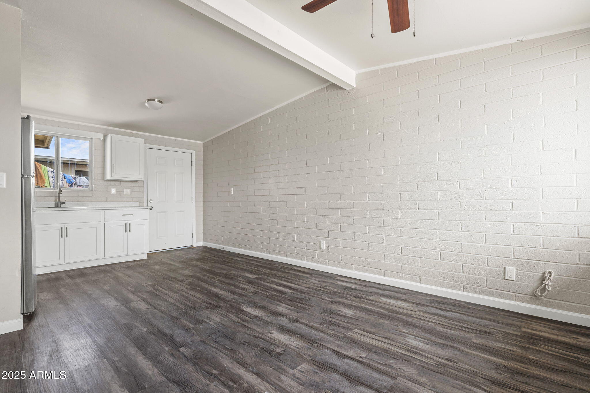 221 5th Avenue East, Unit 225 Buckeye, AZ 85326 - Photo 1 of 14 a view of a kitchen with wooden floor and a sink