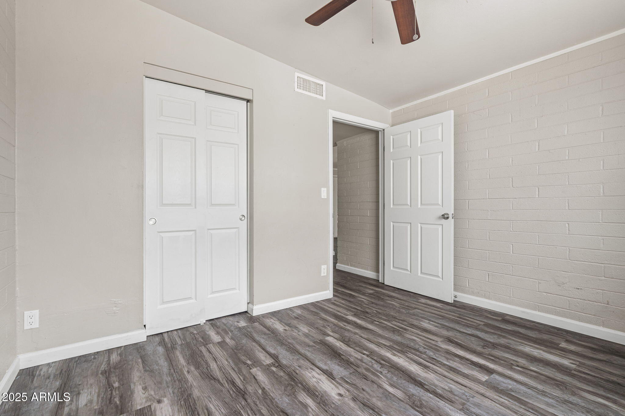 221 5th Avenue East, Unit 225 Buckeye, AZ 85326 - Photo 12 of 14 a view of an empty room with wooden floor