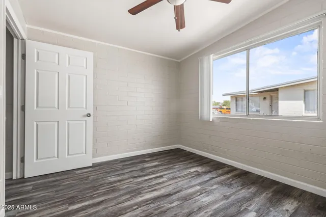wooden floor in an empty room with a window