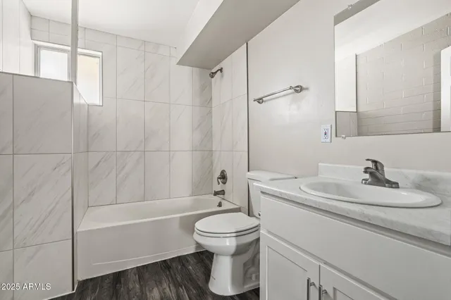 a bathroom with a sink toilet tub and shower