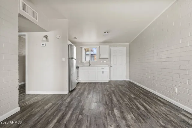 a view of a kitchen with wooden floor