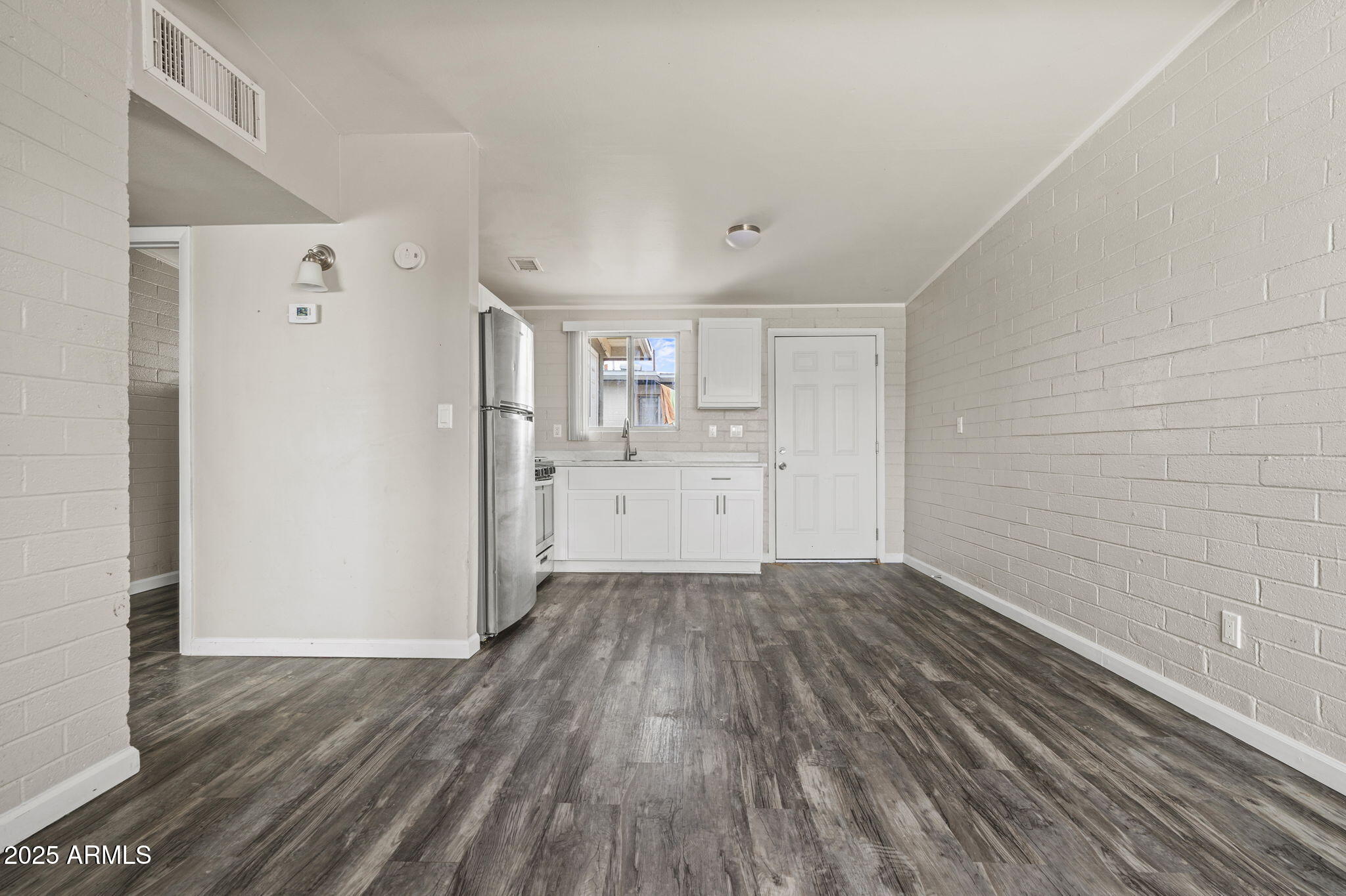 221 5th Avenue East, Unit 225 Buckeye, AZ 85326 - Photo 3 of 14 a view of a kitchen with wooden floor