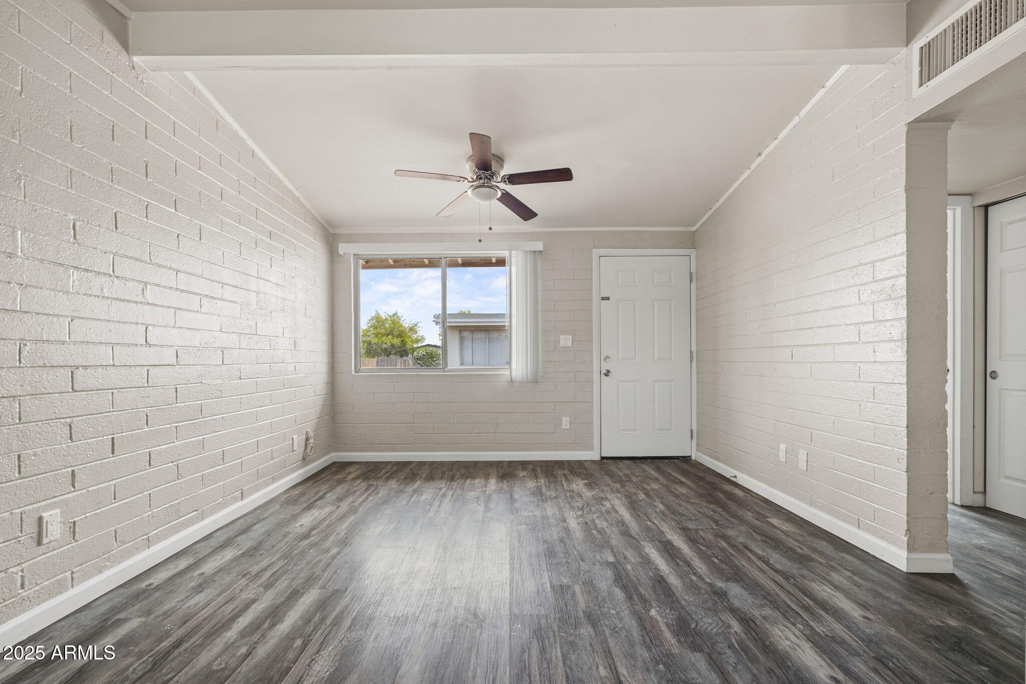221 5th Avenue East, Unit 225 Buckeye, AZ 85326 - Photo 5 of 14 wooden floor in an empty room with a window