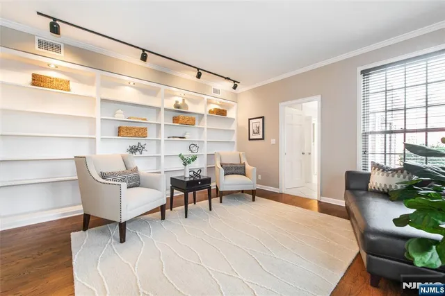 a living room with furniture wooden floor and a table