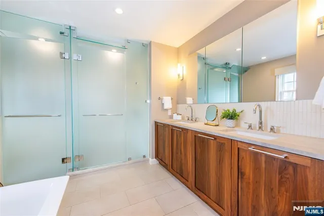a bathroom with a double vanity sink and mirror