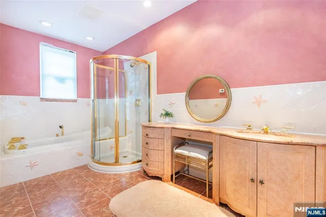 a bathroom with a sink mirror vanity and bathtub