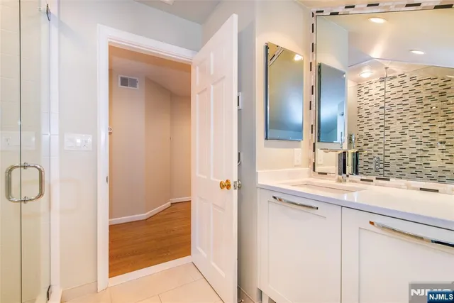 a room with lots of wooden furniture and glass windows