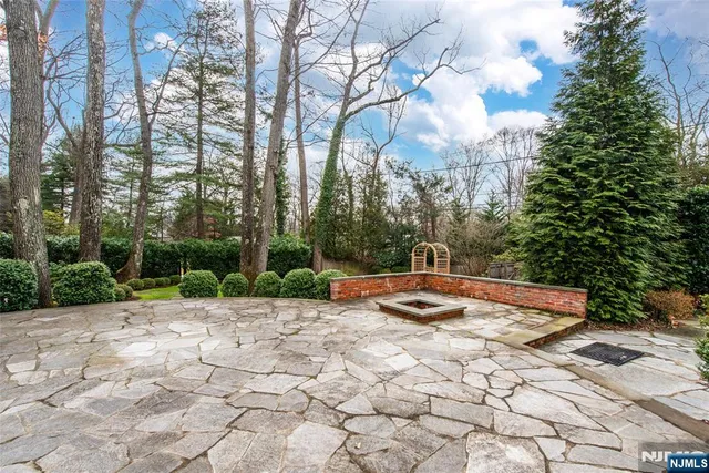 front view of a brick house with a yard