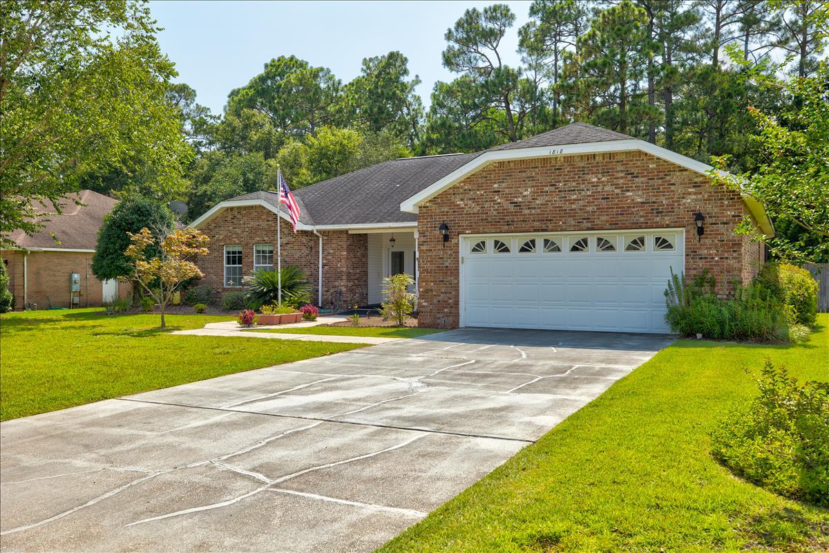 1818 Huntington Road Niceville, FL 32578 - Photo 2 of 53 a front view of house with yard and trees