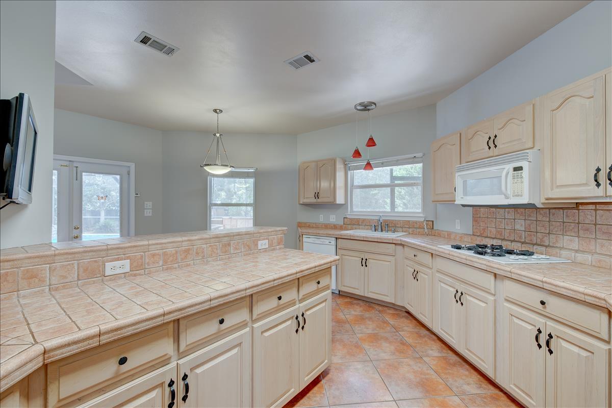 1818 Huntington Road Niceville, FL 32578 - Photo 14 of 53 a kitchen with granite countertop white cabinets and white appliances