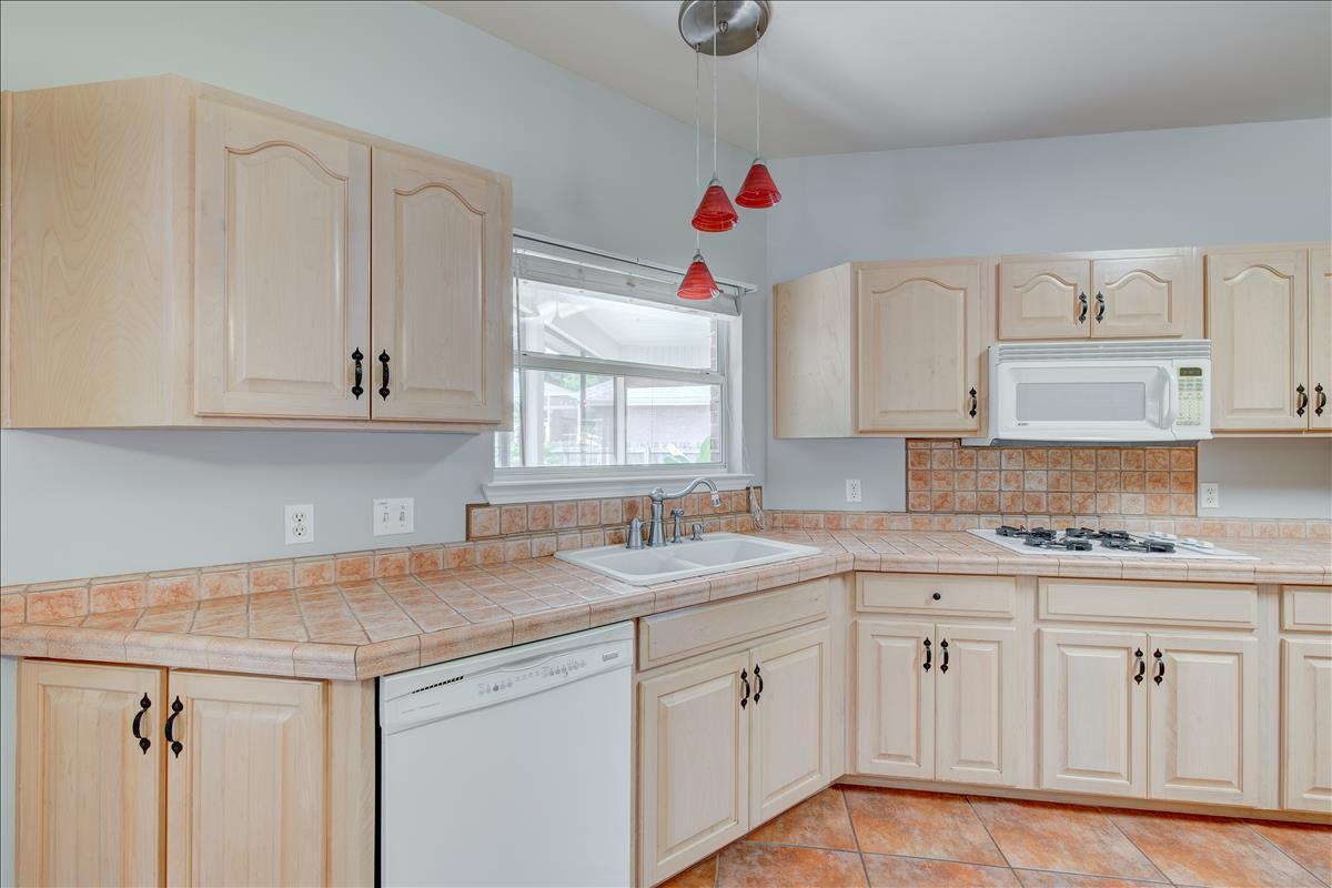 1818 Huntington Road Niceville, FL 32578 - Photo 15 of 53 a kitchen with white cabinets white appliances and sink