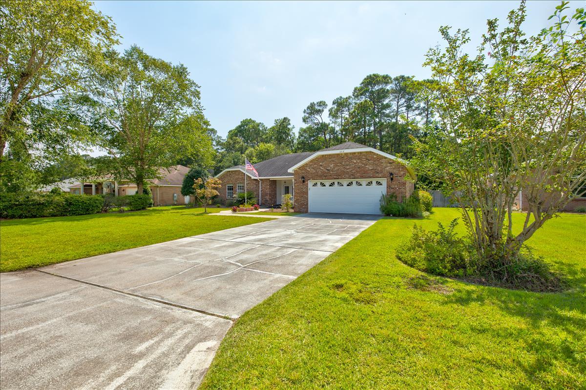1818 Huntington Road Niceville, FL 32578 - Photo 3 of 53 a front view of a house with garden