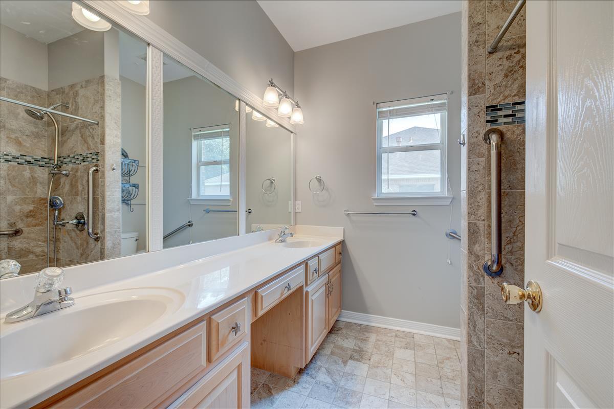 1818 Huntington Road Niceville, FL 32578 - Photo 24 of 53 a spacious bathroom with a double vanity sink a mirror and a shower