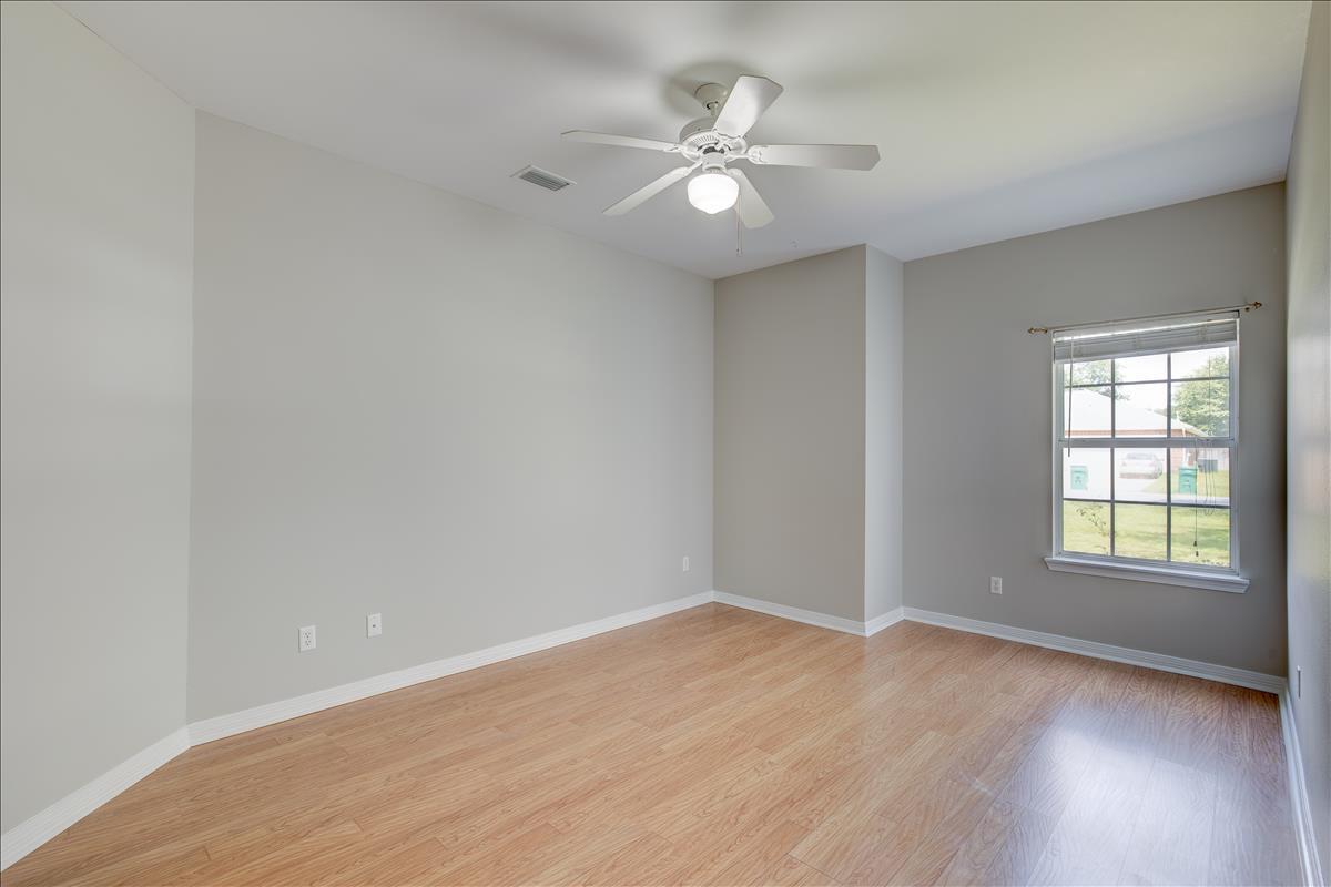 1818 Huntington Road Niceville, FL 32578 - Photo 28 of 53 an empty room with wooden floor and windows
