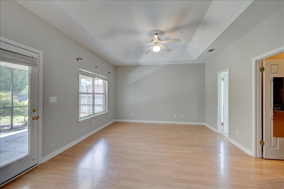 1818 Huntington Road Niceville, FL 32578 - Photo 33 of 53 an empty room with wooden floor chandelier fan and windows