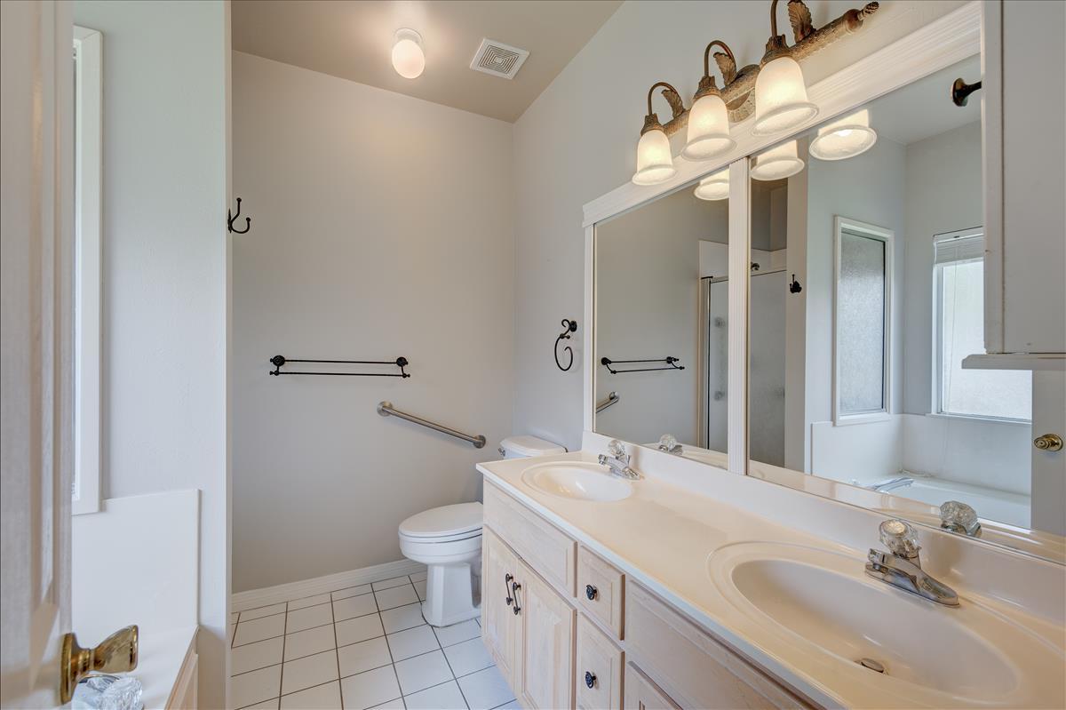 1818 Huntington Road Niceville, FL 32578 - Photo 35 of 53 a bathroom with a sink a toilet and a mirror